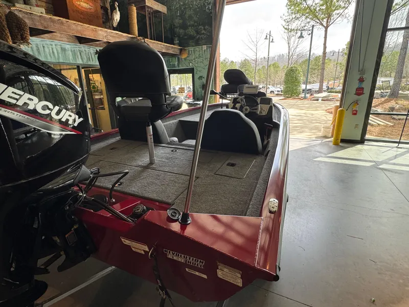 Slide: The Image of 2025 Tracker Pro Team 175 boat in showroom, featuring Mercury engine and dual seating. - 3