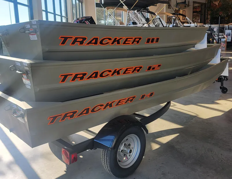 Slide: The Image of 2025 Tracker Grizzly 1236 Utility boats stacked on a trailer in a showroom. - 32