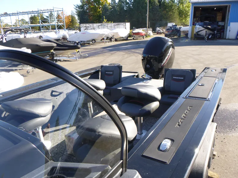 Slide: The Image of 2025 Tracker Targa V-18 Combo boat with seating and motor in a marina setting. - 17