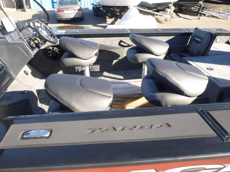 Slide: The Image of 2025 Tracker Targa V-18 Combo boat interior with swivel seats and steering console. - 18