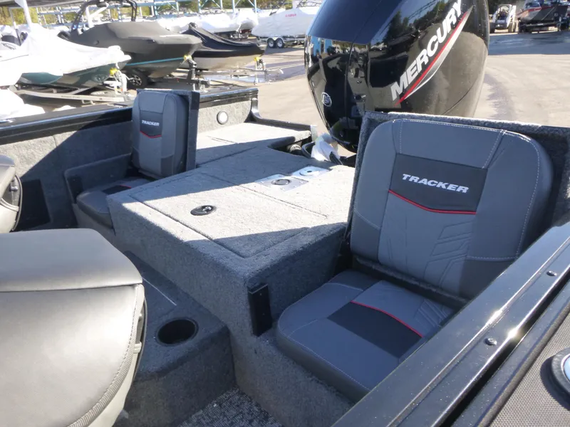 Slide: The Image of 2025 Tracker Targa V-18 Combo boat interior with Mercury engine, featuring cushioned seating. - 19