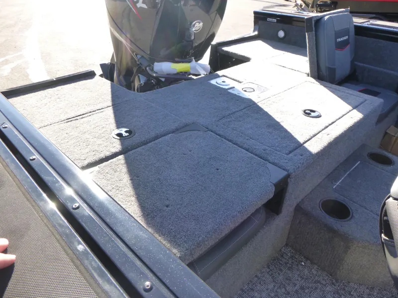 Slide: The Image of 2025 Tracker Targa V-18 Combo boat deck with motor and storage compartments. - 23