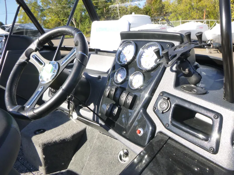 Slide: The Image of 2025 Tracker Targa V-18 Combo dashboard with steering wheel and instrument panel. - 27