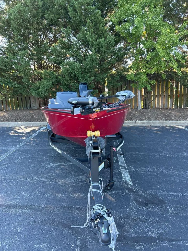 Slide: The Image of 2025 Tracker Super Guide V-16 SC boat on trailer, parked outdoors. - 2