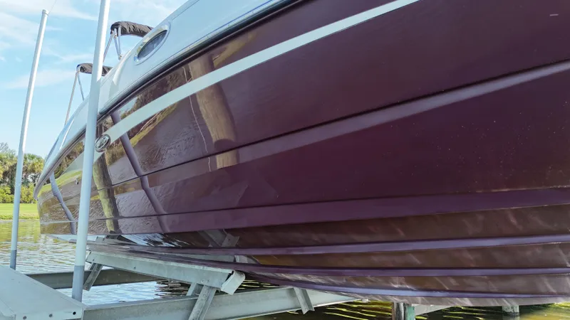 Slide: The Image of 2012 Sea Ray 280 Sundeck boat on a lift, side view. - 11