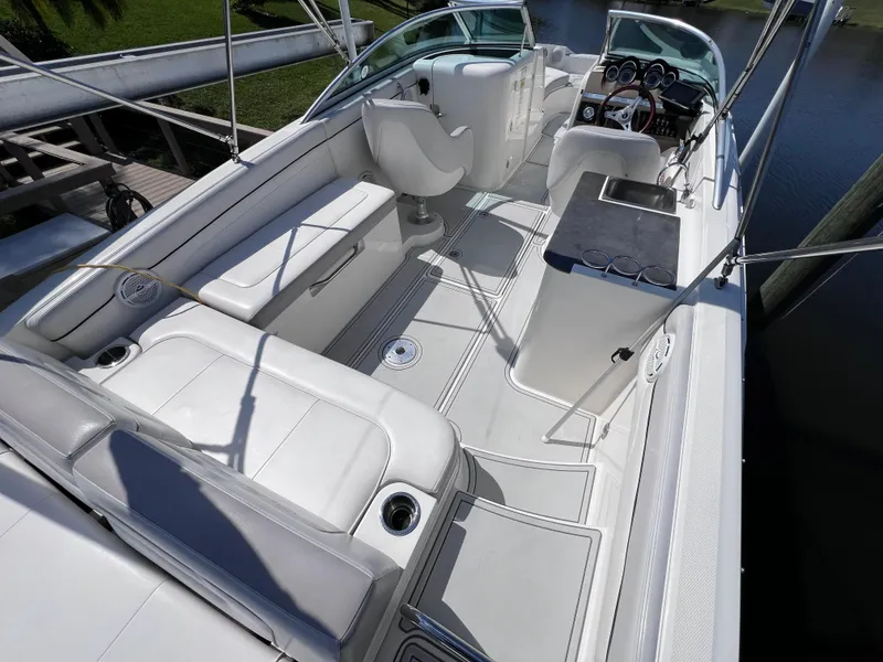 Slide: The Image of 2012 Sea Ray 280 Sundeck boat interior with white seating and helm. - 19
