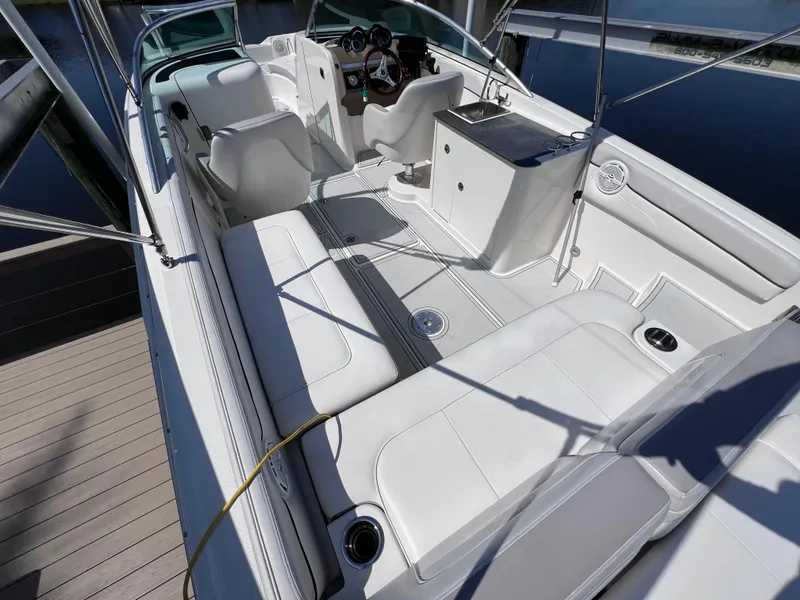Slide: The Image of 2012 Sea Ray 280 Sundeck boat interior with white seating and helm. - 20