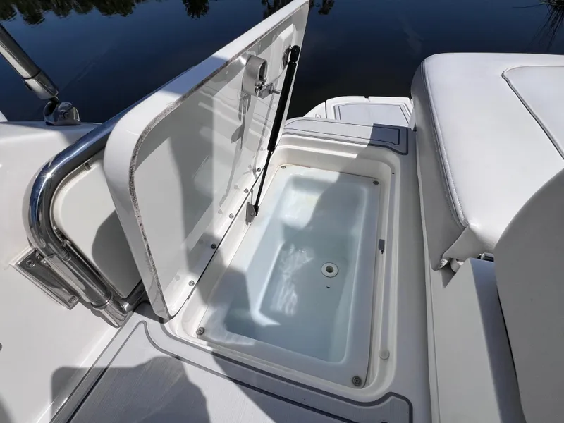 Slide: The Image of 2012 Sea Ray 280 Sundeck storage compartment with open hatch, showcasing interior space. - 23