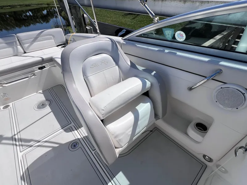 Slide: The Image of 2012 Sea Ray 280 Sundeck interior with white seating and speaker detail. - 27
