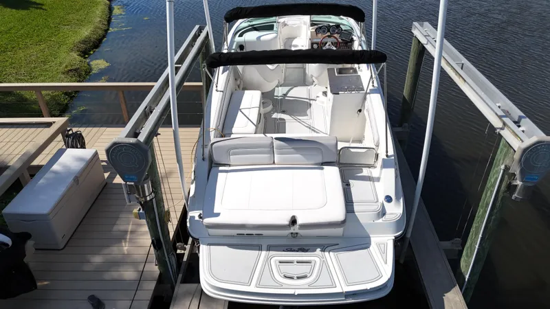 Slide: The Image of 2012 Sea Ray 280 Sundeck boat docked on a lift by the water. - 3