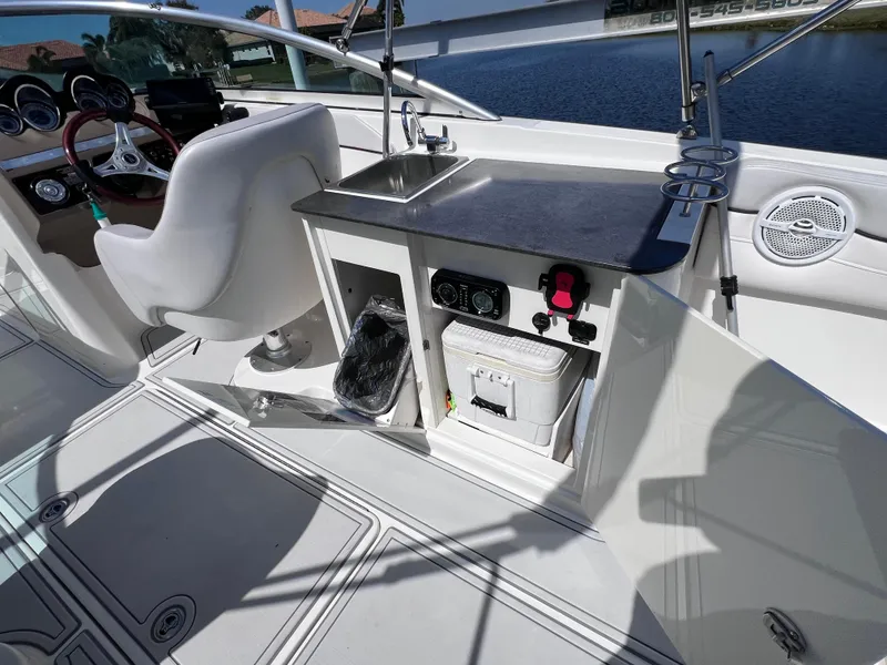 Slide: The Image of 2012 Sea Ray 280 Sundeck boat interior with sink and storage compartments. - 31