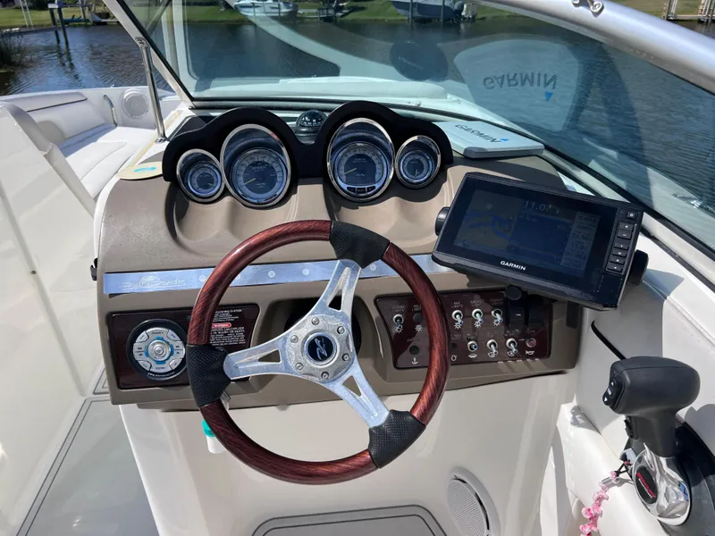 Slide: The Image of 2012 Sea Ray 280 Sundeck dashboard with steering wheel and navigation system. - 33