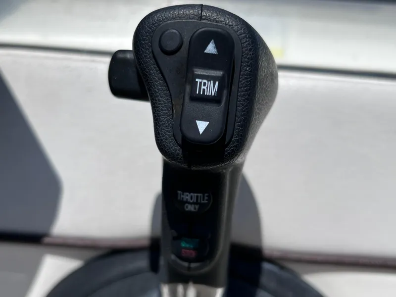 Slide: The Image of Throttle control lever of 2012 Sea Ray 280 Sundeck boat with trim adjustment buttons. - 39