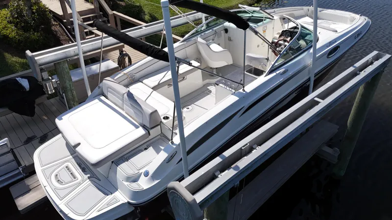 Slide: The Image of 2012 Sea Ray 280 Sundeck boat docked, featuring spacious seating and sleek design. - 4