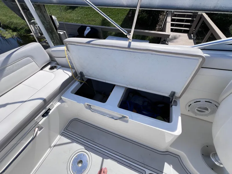 Slide: The Image of 2012 Sea Ray 280 Sundeck boat interior with open storage compartments. - 44