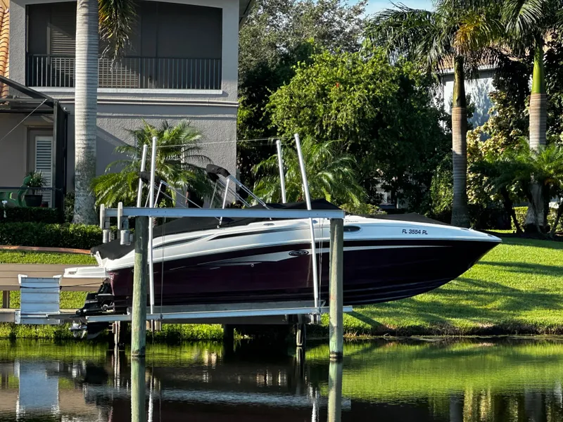 Slide: The Image of 2012 Sea Ray 280 Sundeck boat docked by a lush waterfront property. - 7