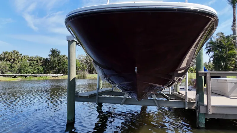 Slide: The Image of 2012 Sea Ray 280 Sundeck boat on lift, surrounded by water and trees. - 9