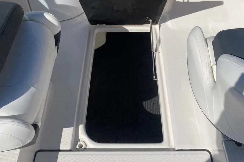 Slide: The Image of 2023 Robalo R207 Dual Console boat storage compartment with open hatch. - 5