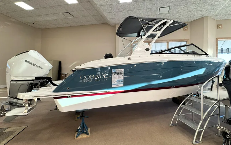 The Image of 2025 Cobalt R6 Outboard boat displayed indoors with Mercury engine. - 0