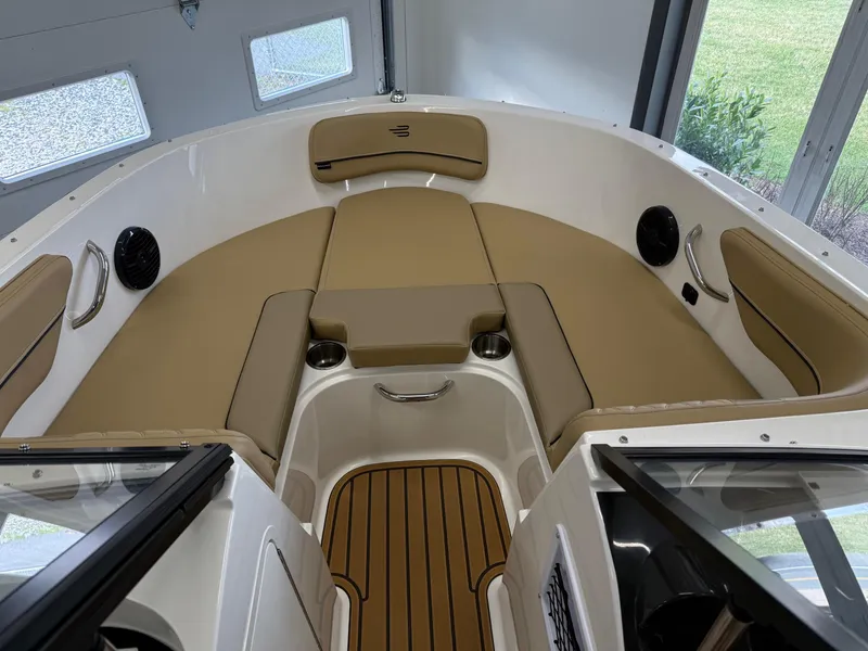 Slide: The Image of 2025 Bayliner VR4 Bowrider OB interior with tan seating and wood accents. - 10