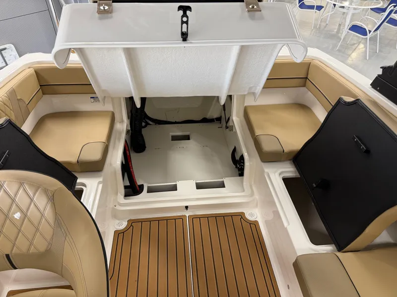 Slide: The Image of 2025 Bayliner VR4 Bowrider OB interior with tan seating and storage compartments. - 6