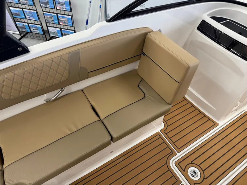 Slide: The Image of 2025 Bayliner VR4 Bowrider OB interior with tan seating and wood-style flooring. - 7