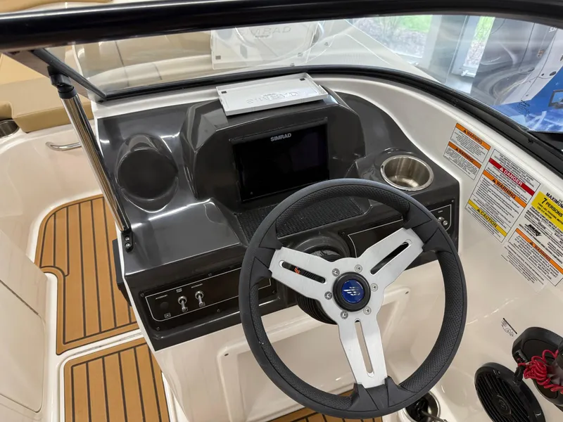 Slide: The Image of 2025 Bayliner VR4 Bowrider OB dashboard with steering wheel and control panel. - 9