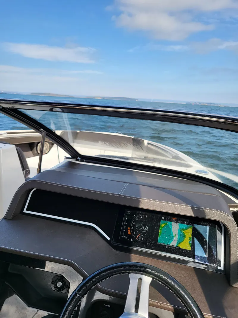 Slide: The Image of 2016 Sea Ray 280 SLX dashboard with navigation screen, ocean view in background. - 11