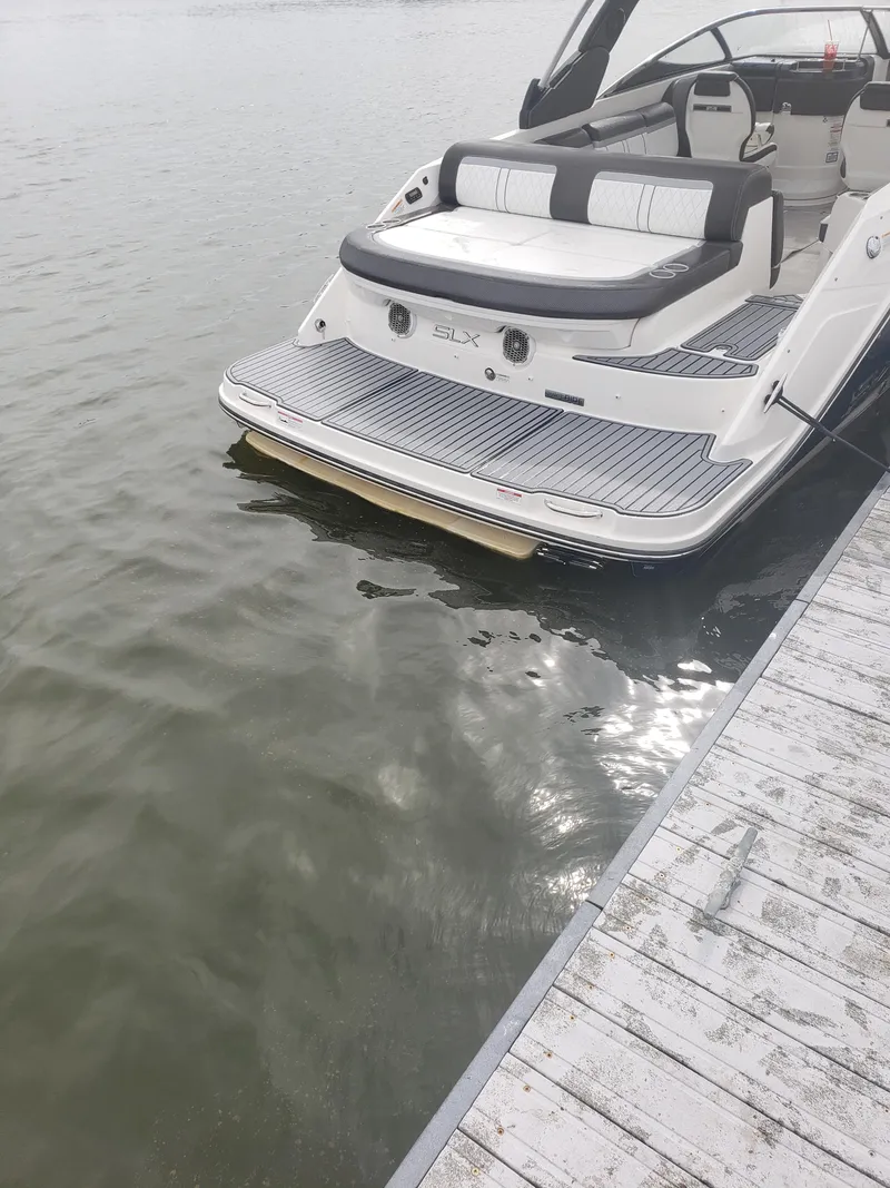 Slide: The Image of 2016 Sea Ray 280 SLX boat docked on calm water. - 12