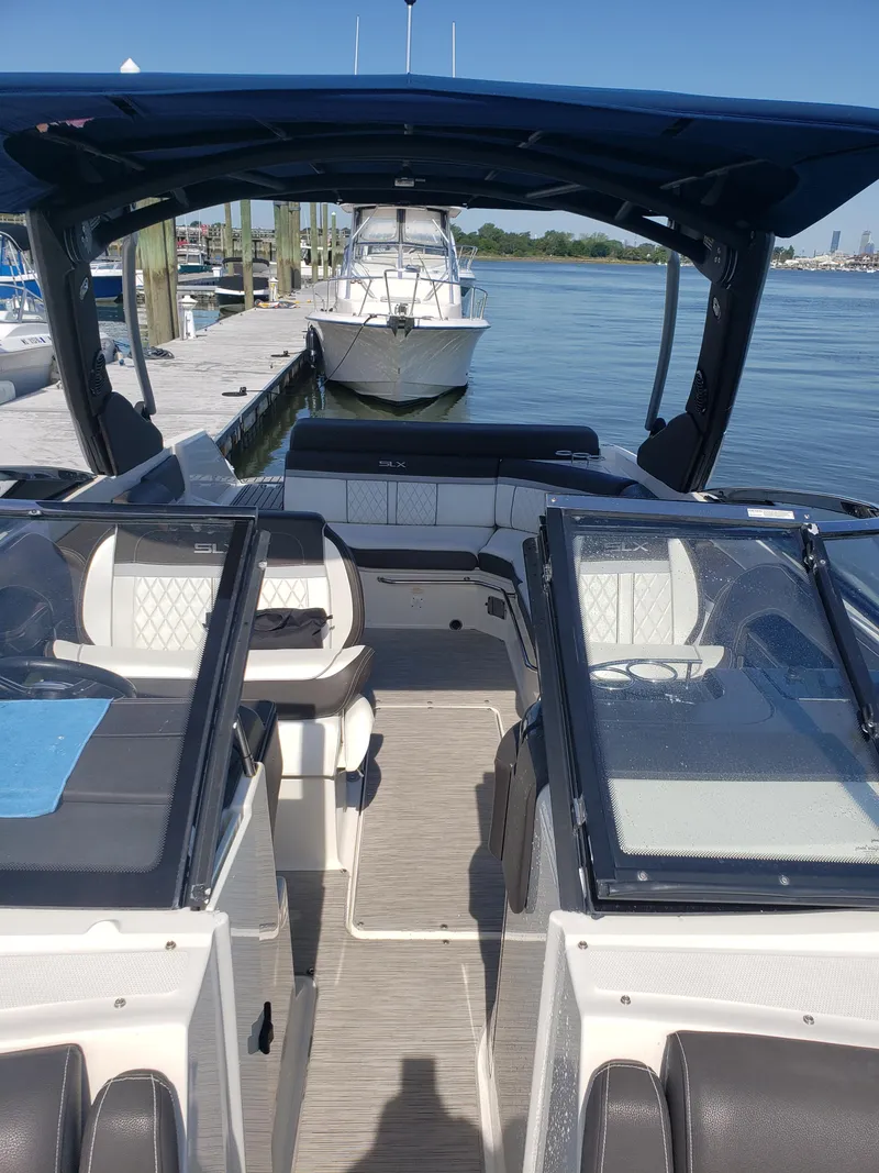Slide: The Image of 2016 Sea Ray 280 SLX boat docked at marina, featuring spacious seating and sleek design. - 13