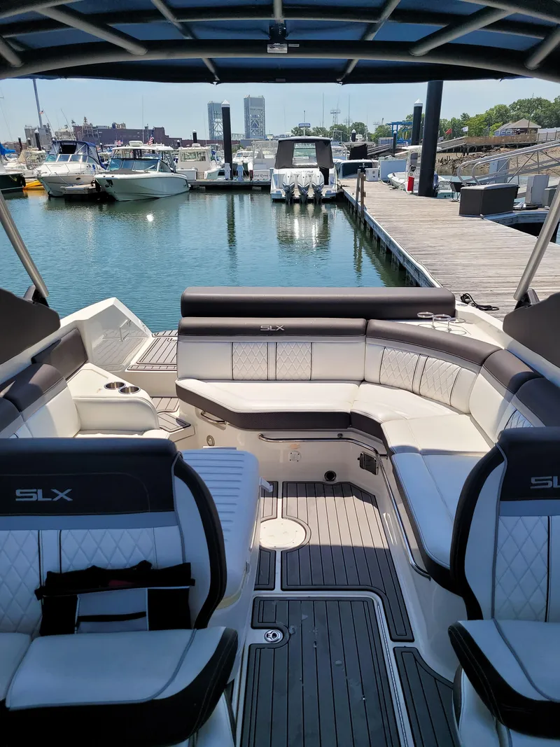 Slide: The Image of 2016 Sea Ray 280 SLX boat interior at marina, featuring luxurious seating and waterfront view. - 14