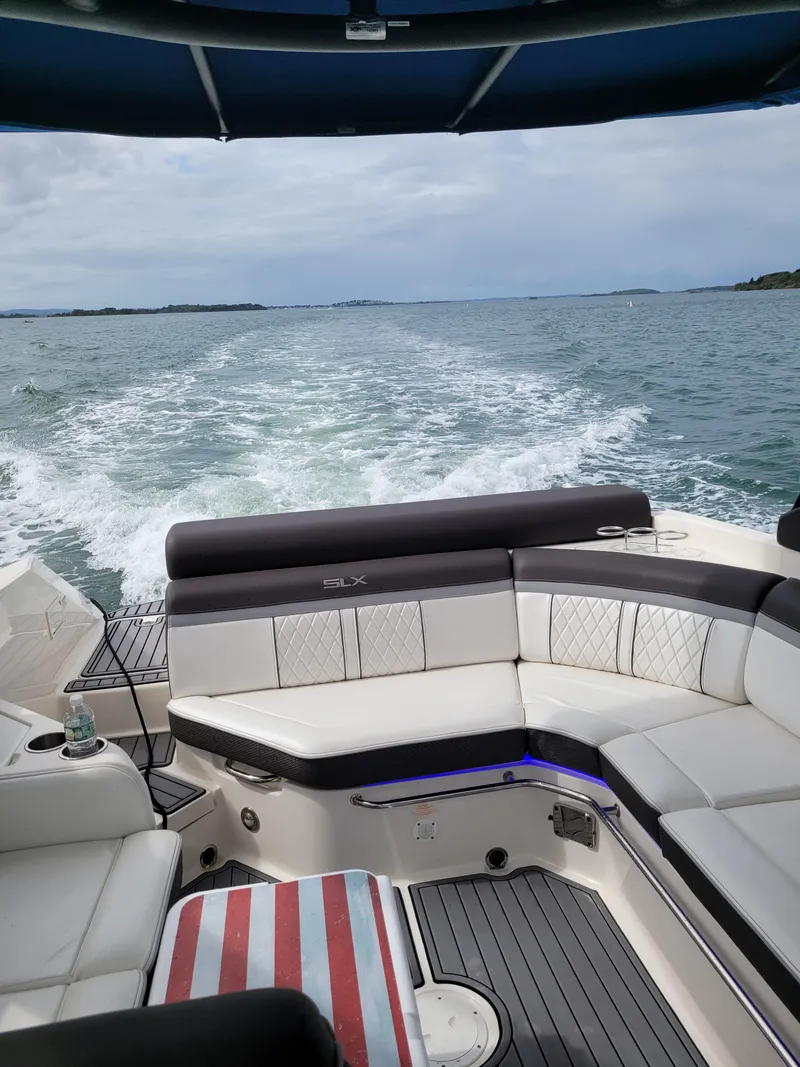 Slide: The Image of 2016 Sea Ray 280 SLX cruising on open water, featuring luxurious seating and wake trail. - 17