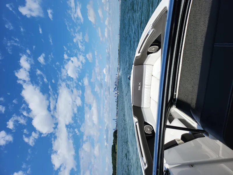 Slide: The Image of 2016 Sea Ray 280 SLX boat on open water under a blue sky. - 18