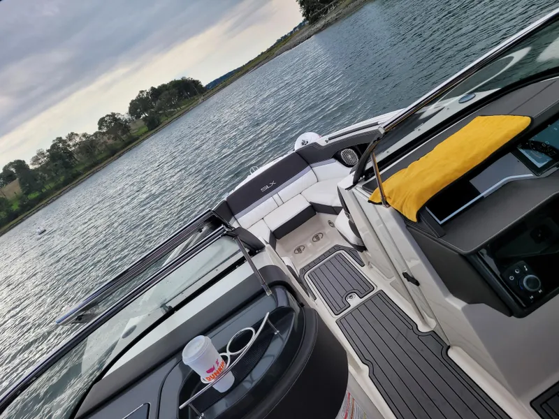 Slide: The Image of 2016 Sea Ray 280 SLX boat interior on a calm lake. - 19