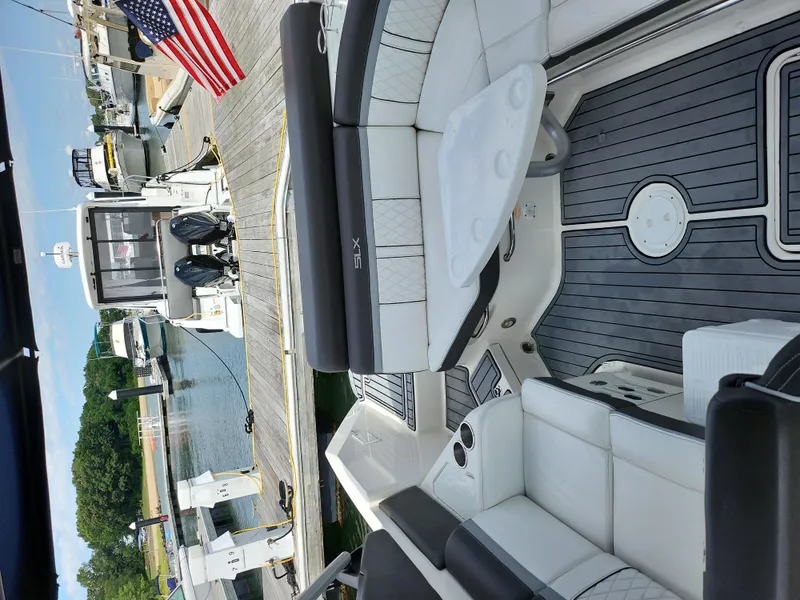 Slide: The Image of Interior of 2016 Sea Ray 280 SLX boat docked at marina with American flag. - 20