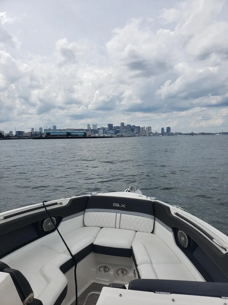 Slide: The Image of 2016 Sea Ray 280 SLX boat on water with city skyline in background. - 21