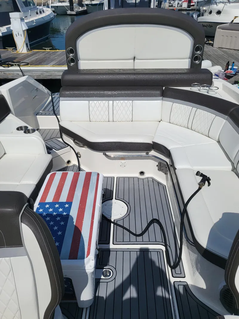 Slide: The Image of 2016 Sea Ray 280 SLX boat interior with American flag cooler on deck. - 24