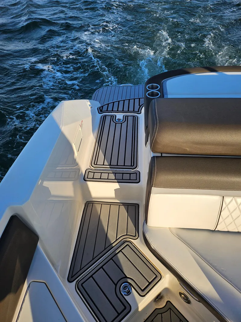 Slide: The Image of 2016 Sea Ray 280 SLX boat deck with cushioned seating on water. - 27