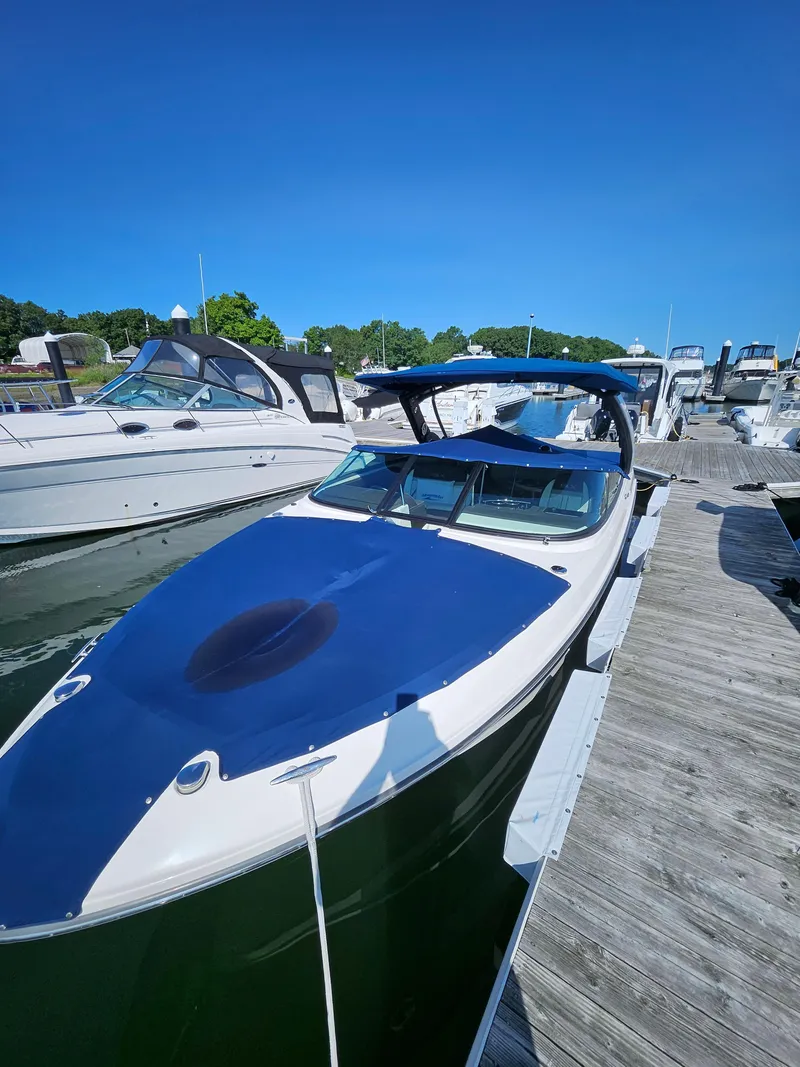 Slide: The Image of 2016 Sea Ray 280 SLX boat docked at marina under clear blue sky. - 33