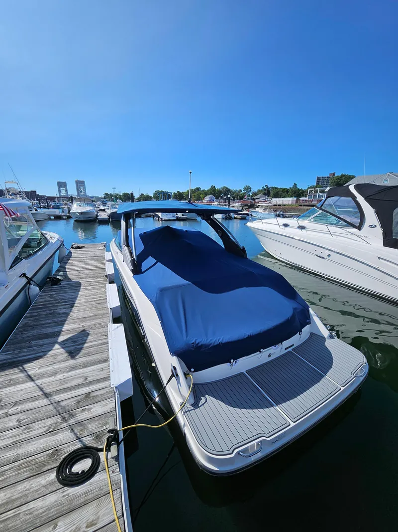Slide: The Image of 2016 Sea Ray 280 SLX boat docked at marina under clear blue sky. - 34