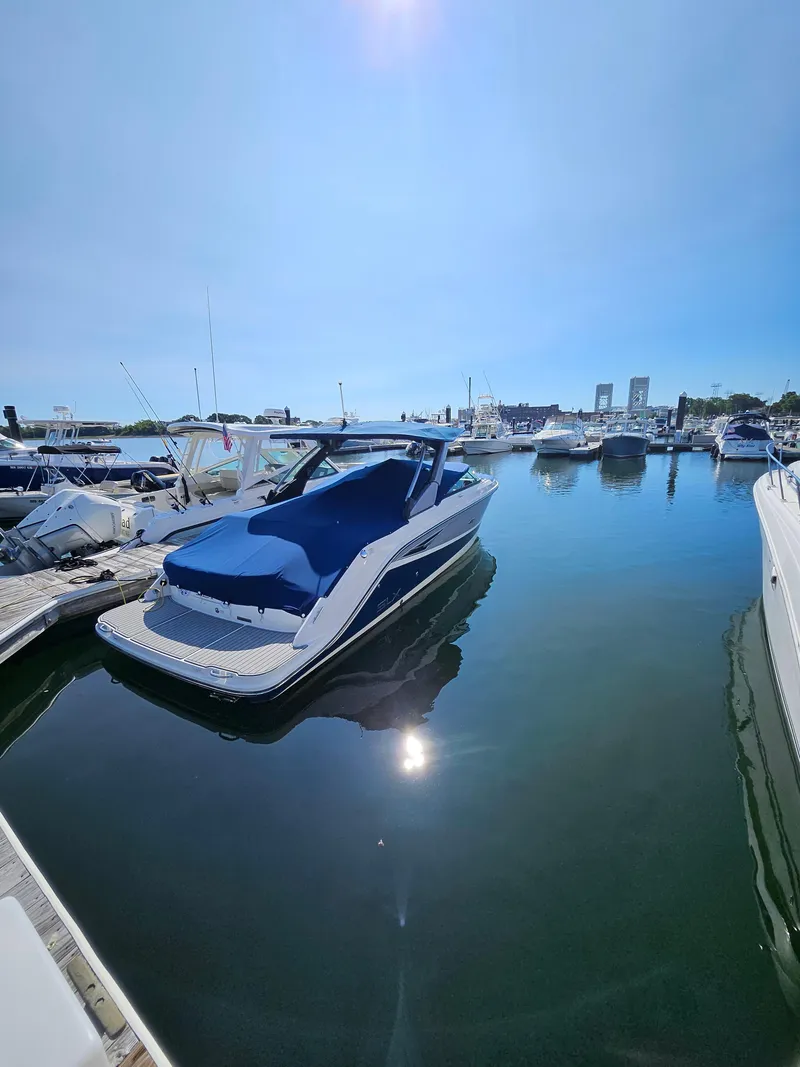 Slide: The Image of 2016 Sea Ray 280 SLX boat docked in a sunny marina. - 35