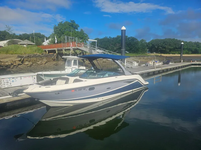 Slide: The Image of 2016 Sea Ray 280 SLX boat docked at a marina under a clear blue sky. - 39