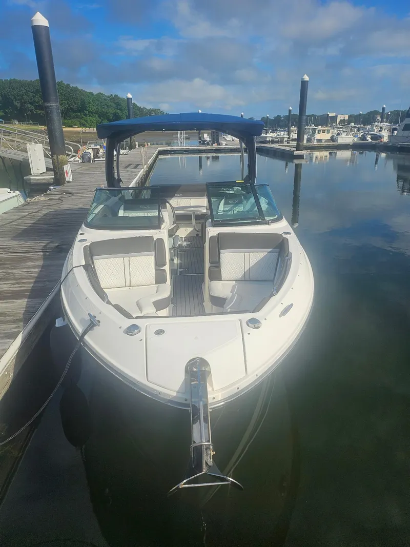 Slide: The Image of 2016 Sea Ray 280 SLX boat docked at marina under clear blue sky. - 40