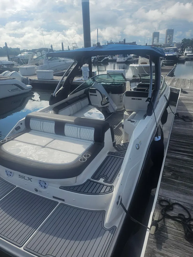 Slide: The Image of 2016 Sea Ray 280 SLX boat docked at marina, featuring spacious seating and sleek design. - 42