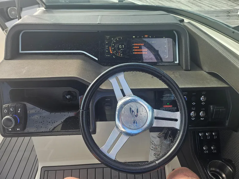Slide: The Image of Steering wheel and dashboard of a 2016 Sea Ray 280 SLX boat. - 44