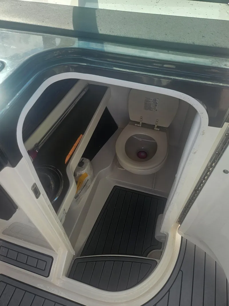 Slide: The Image of Interior view of 2016 Sea Ray 280 SLX boat bathroom with toilet and storage. - 47