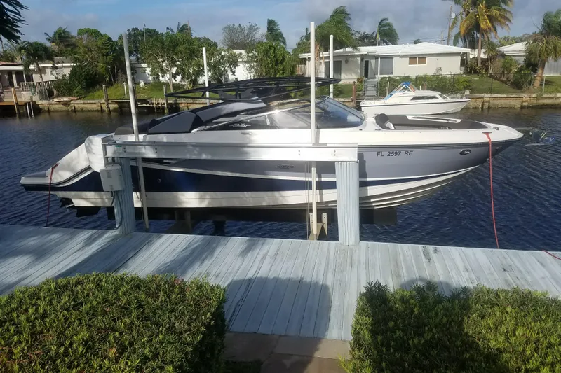 Slide: The Image of 2016 Sea Ray 280 SLX boat docked on a sunny waterfront. - 8