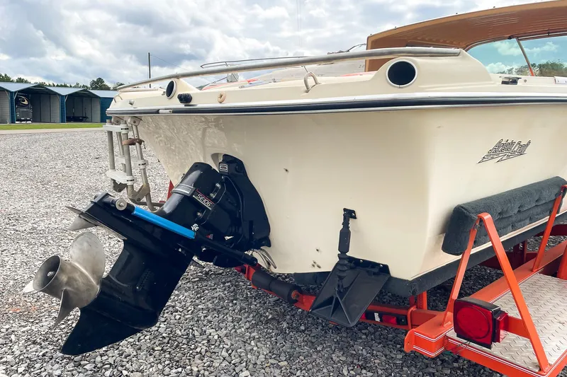 Slide: The Image of 1975 AristoCraft 19 boat on trailer, showcasing outboard motor and sleek design. - 12