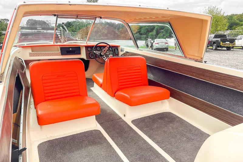 Slide: The Image of 1975 AristoCraft 19 boat interior with orange seats and vintage dashboard. - 15