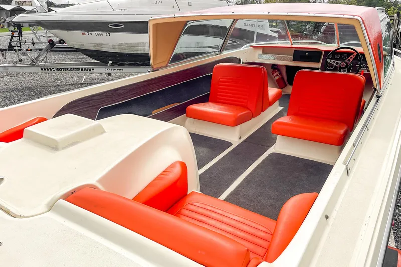 Slide: The Image of 1975 AristoCraft 19 boat with vibrant red seating and sleek interior design. - 17